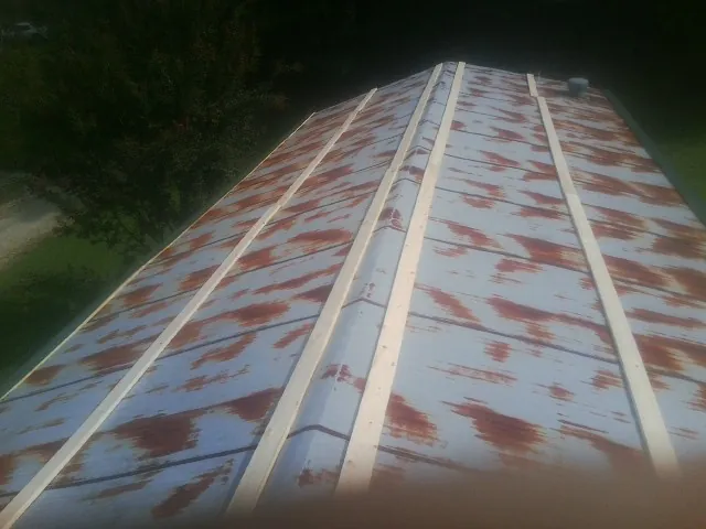 Rusted metal roof panels with new wood purlins before replacement — Storm Damage Roof Repair in Cranesville by Roofing Brothers
