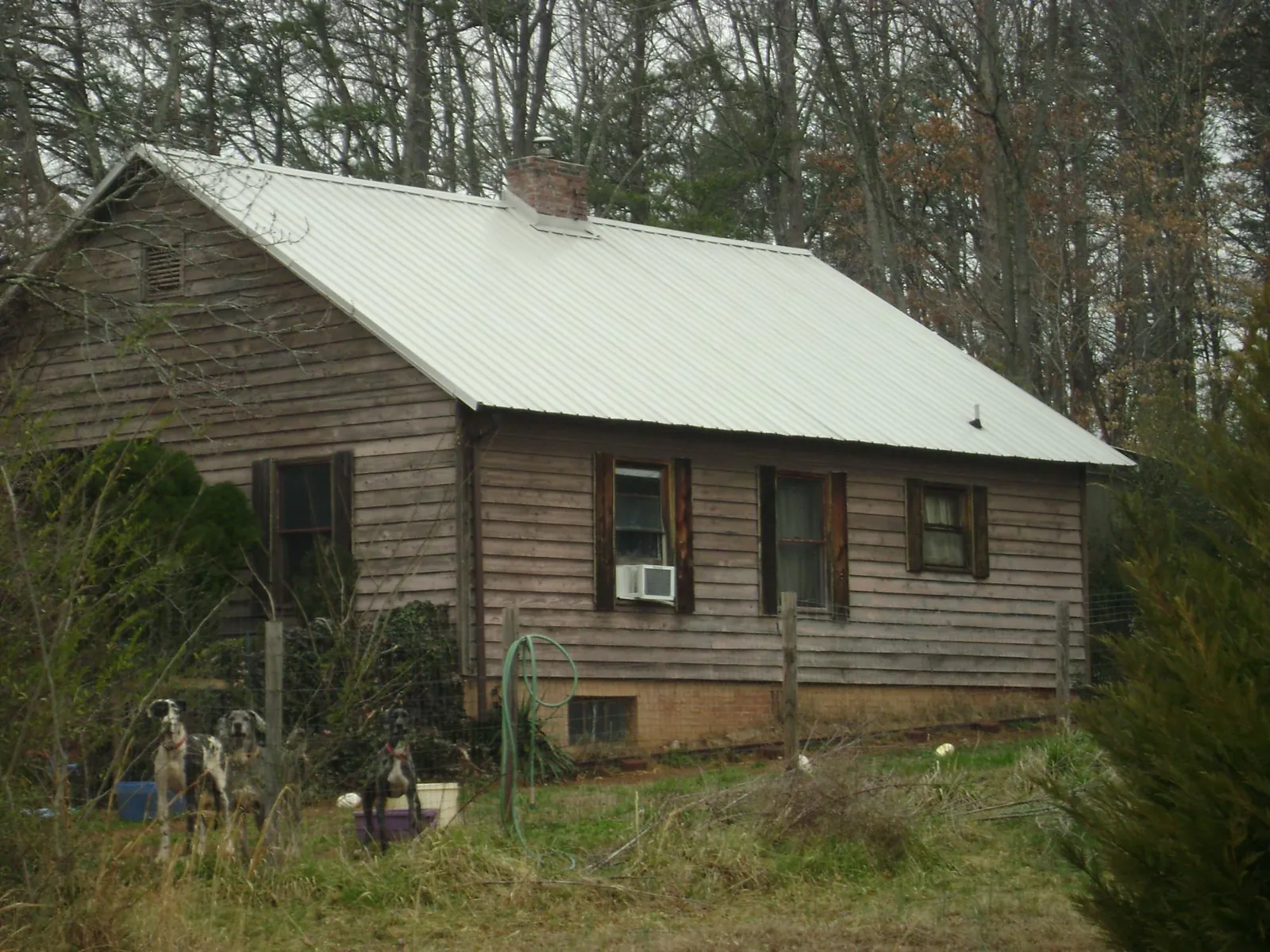 White metal roof on an old wood sided farmhouse, from a Metal Roof Installation job in Cranesville